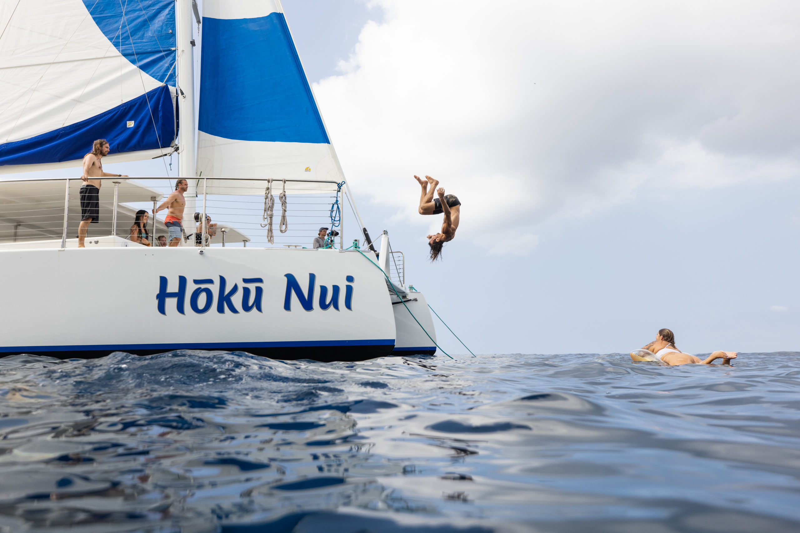 boy jumping off boat