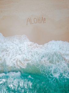 beach sand with words aloha